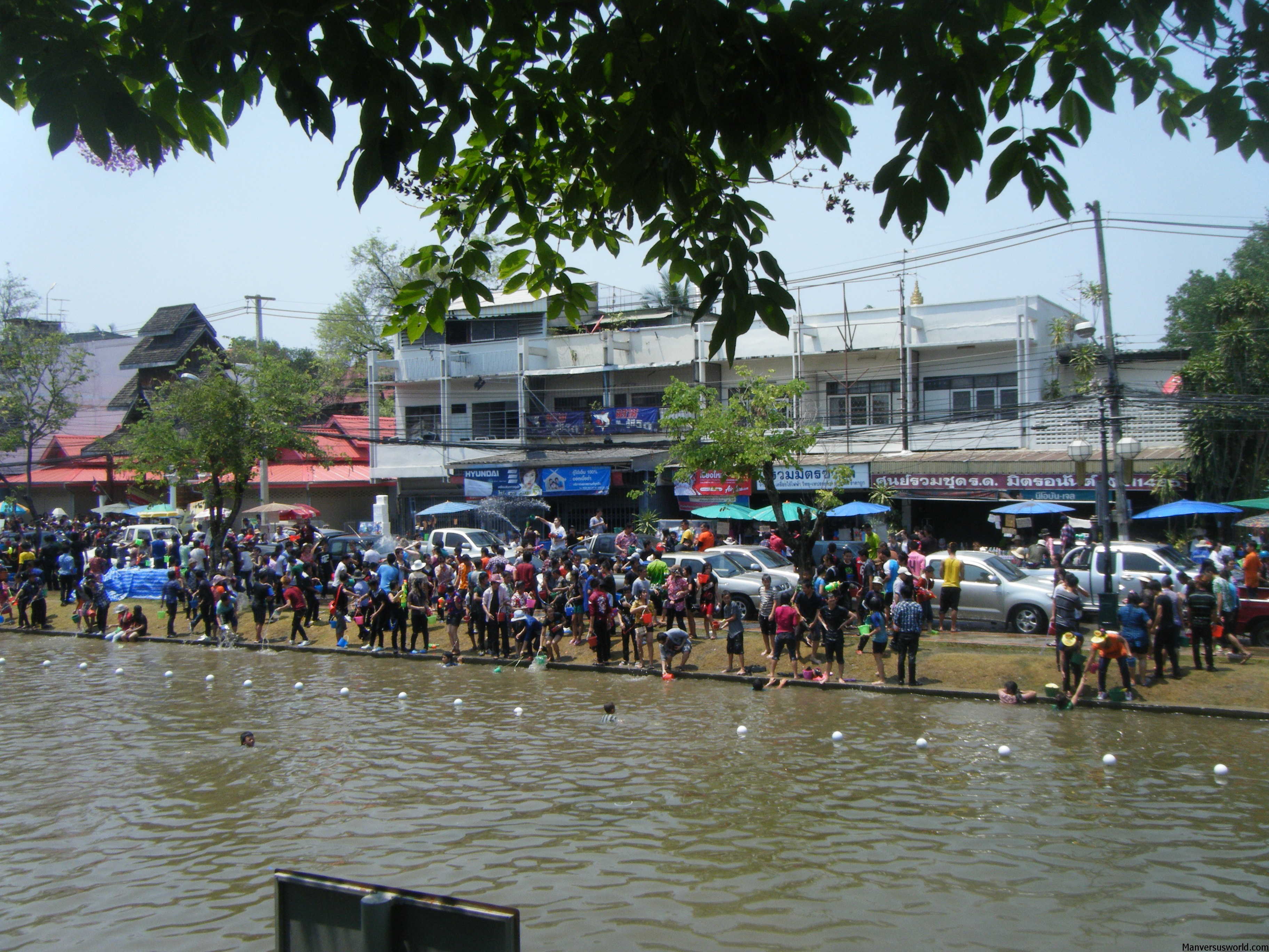 Crowds gather by the water in Chiang Mai for Songkran