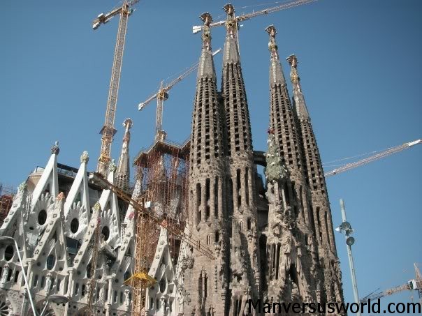 Cranes tower above the La Sagrada Familia Basilica in Barcelona, Spain