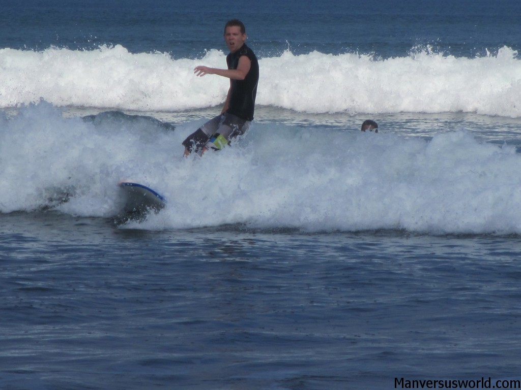 I wipeout while learning to surf on Kuta Beach, Bali