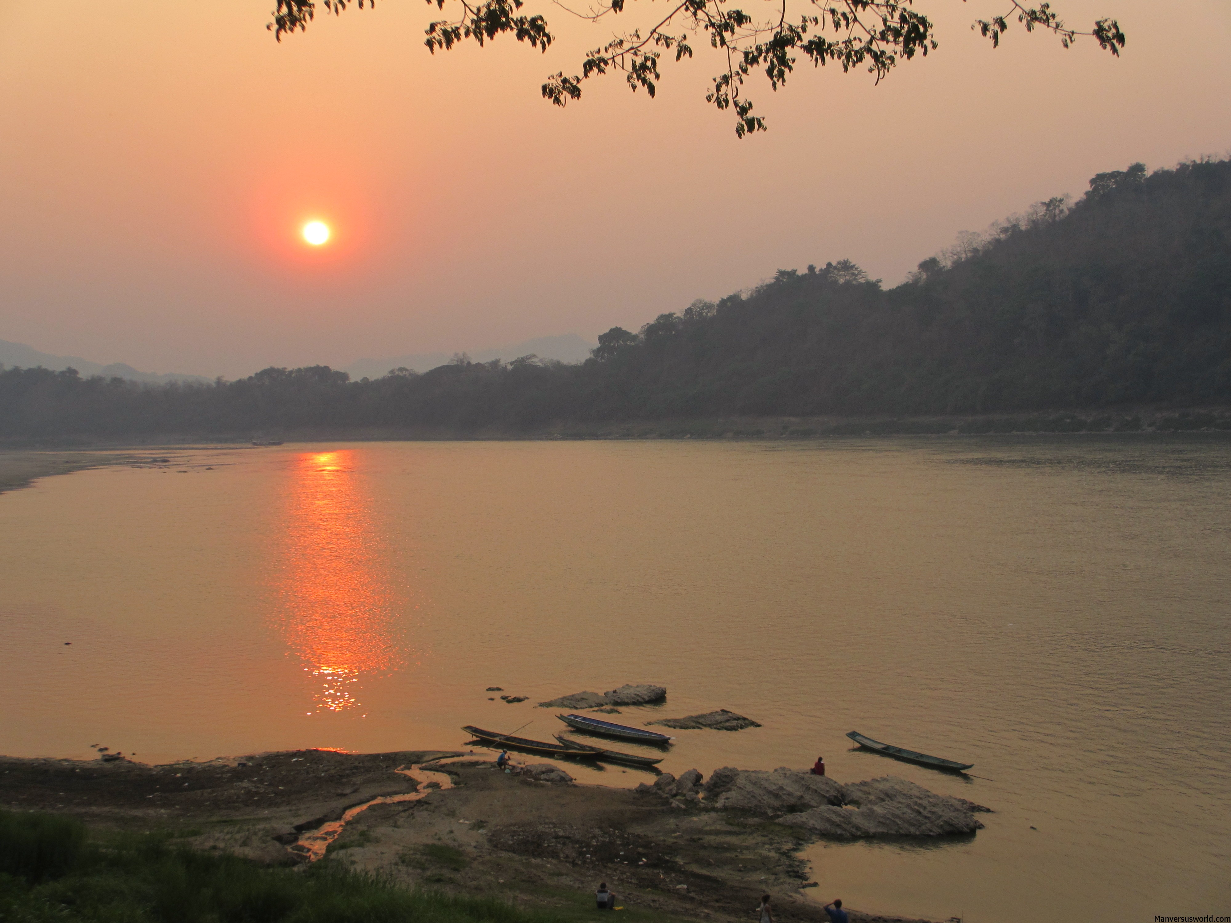 The sun sets over the Mekong in Luang Prabang, Laos