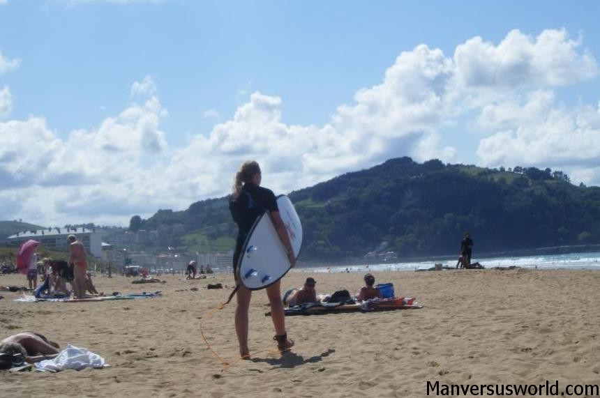 A surfer on the beach in San Sebastian