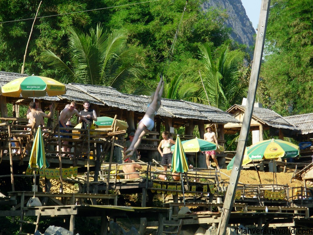 A tuber swinging from a zip-line in Vang Vieng, Laos