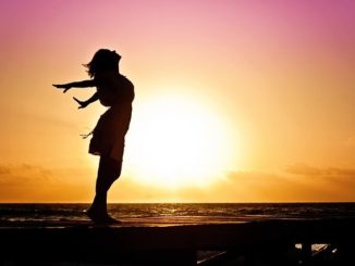 Woman on beach at sunset